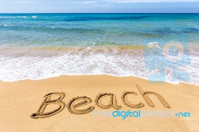 Word Beach Written In Sand At Greek Sea Stock Photo