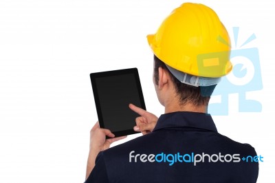 Worker Operating Tablet Device, Back Pose Stock Photo