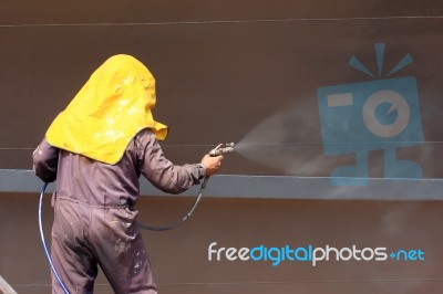 Worker Painting Ship Hull Stock Photo