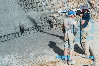 Worker Pumping Concrete Stock Photo