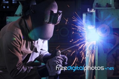 Worker Welding And Bright Sparks Stock Photo