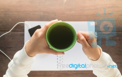 Working Creative Table And Hot Green Tea Drinking Stock Photo