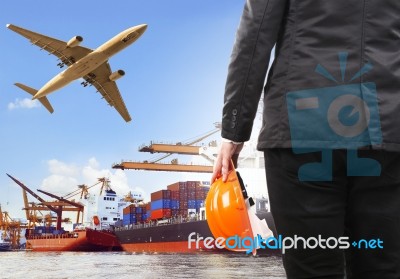 Working Man And Commercial Ship On Port And Air Cargo Plane Flyi… Stock Photo