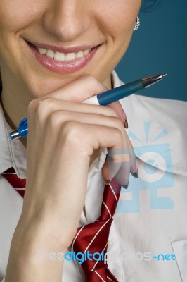 Working Woman Thinking With A Pen In Hand Stock Photo