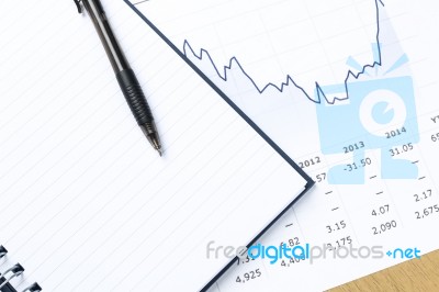 Workplace With Pen, Notebook, Financial Report Stock Photo