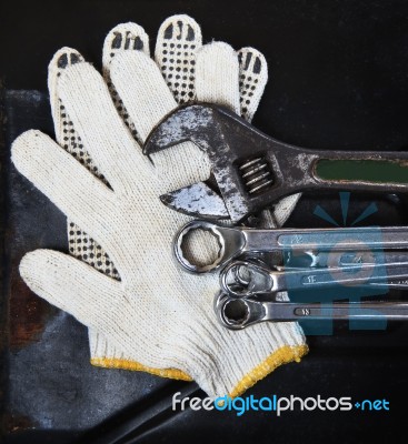 Wrenches Spanners Plumbing And Mechanic Glove On Dark Metal Back… Stock Photo