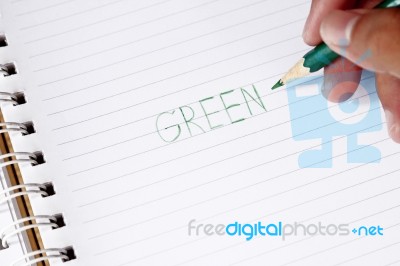 Write The Word Green With Green Pencil In Blur Man's Hands Stock Photo