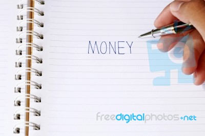 Write The Word Money With Pen In Blur Man's Hands Stock Photo