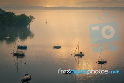 Yachts In The Early Morning Mist At Lesa Lake Maggiore Piedmont Stock Photo