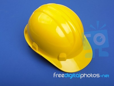 Yello Hard hat On Blue Stock Photo