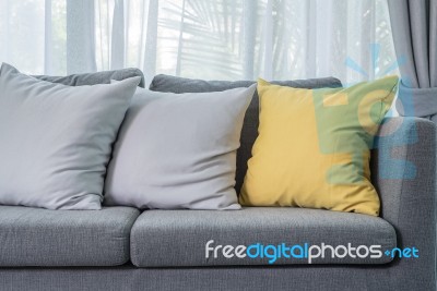 Yellow And Grey Pillows On Modern Sofa Stock Photo