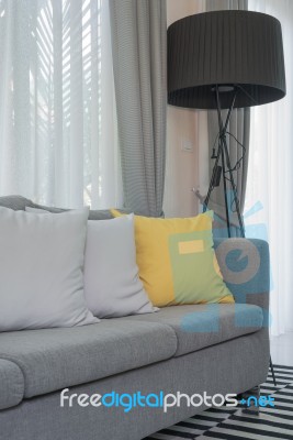 Yellow And Grey Pillows On Modern Sofa Stock Photo