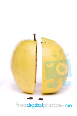 Yellow Apple Sliced In Half On White Stock Photo