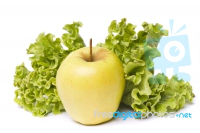 Yellow Apple With Lettuce On White Stock Photo