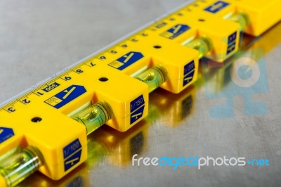Yellow Construction Level On Stainless Steel Background Stock Photo