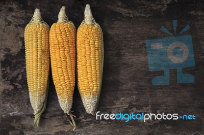 Yellow Corn On Wood Background Stock Photo