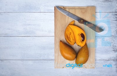 Yellow Egg Fruit On Wood Cutting Board Stock Photo