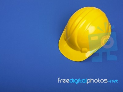 Yellow Hard Hat On Blue Stock Photo