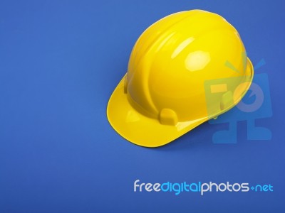 Yellow Hard hat On Blue Stock Photo