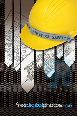 Yellow Hard Hat With Blueprints Stock Photo