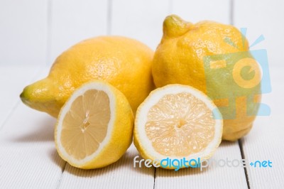 Yellow Lemons Over White Wood Background Stock Photo