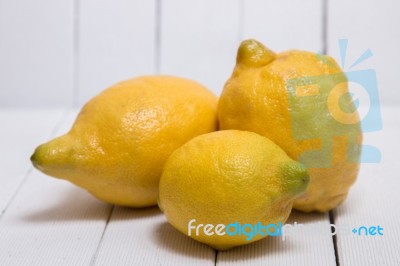 Yellow Lemons Over White Wood Background Stock Photo