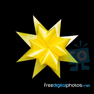 Yellow Ribbon Flower Made With Folded Hands On Black Background Stock Photo