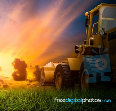 Yellow Tractor In A Field Stock Photo