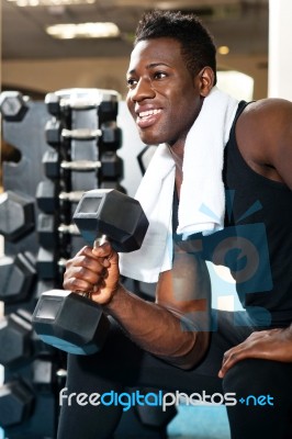 Young African Male Holding Dumbbell Stock Photo