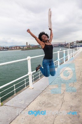 Young African Woman Jumping Stock Photo