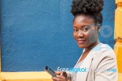 Young African Woman With A Smartphone Stock Photo