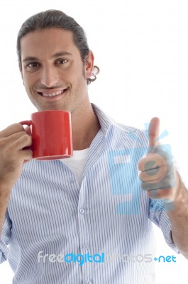 Young American Male Holding Coffee Mug With Thumbs Up Stock Photo