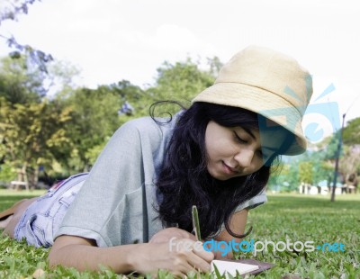 Young Asia Girl Writting A Book Stock Photo