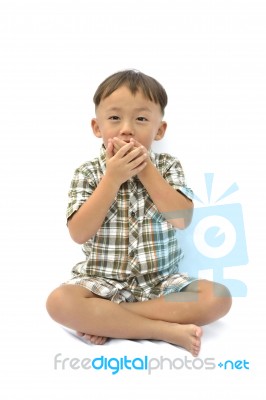 Young Asian Boy Closing Mouth Stock Photo