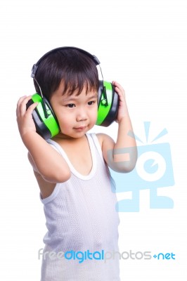 Young Asian Boy In A White Singlet Wearing Earmuffs Stock Photo