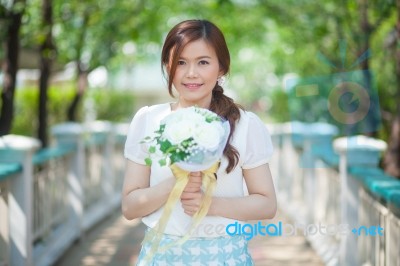 Young Asian Cute Woman Smelling White Flowers Stock Photo