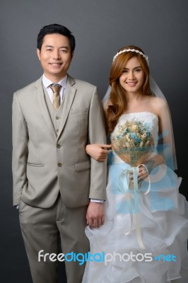 Young Asian Groom And Bride Posing In Studio For Pre Wedding Sho… Stock Photo