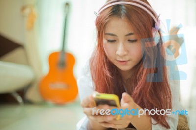 Young Asian Woman Listening To Music Stock Photo