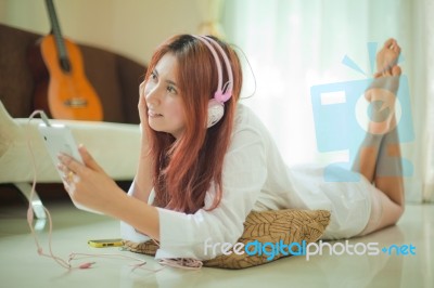 Young Asian Woman Listening To Music Stock Photo