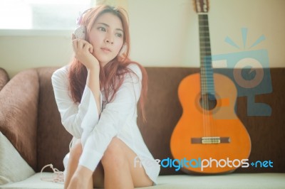 Young Asian Woman Listening To Music Stock Photo