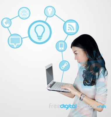 Young Asian Woman Using Laptop With Technology Icons Stock Photo