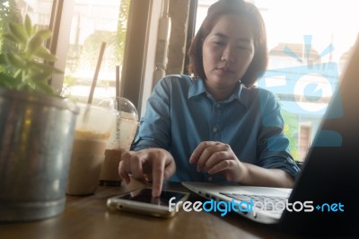 Young Asian Woman Working In Coffee Shop Stock Photo