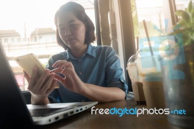 Young Asian Woman Working In Coffee Shop Stock Photo