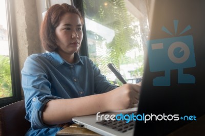 Young Asian Woman Working In Coffee Shop Stock Photo