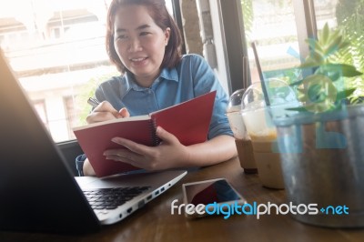 Young Asian Woman Working In Coffee Shop Stock Photo