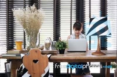 Young Asian Working Woman Is Using A Laptop With Vintage Decoration Stock Photo