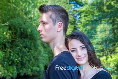 Young Attractive Woman Leaning Head On Back Of Man Stock Photo