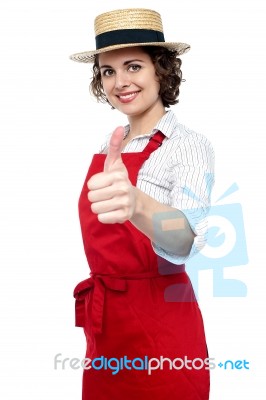 Young Baker Woman Gesturing Thumbs Up Stock Photo