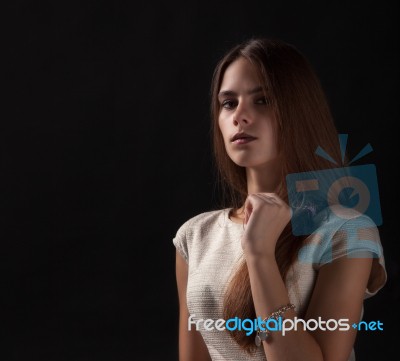 Young Beautiful Girl On A Black Background Stock Photo