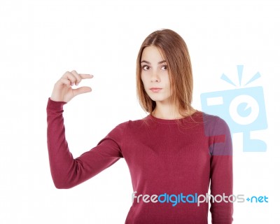 Young Beautiful Girl Showing A Little Gesture Stock Photo